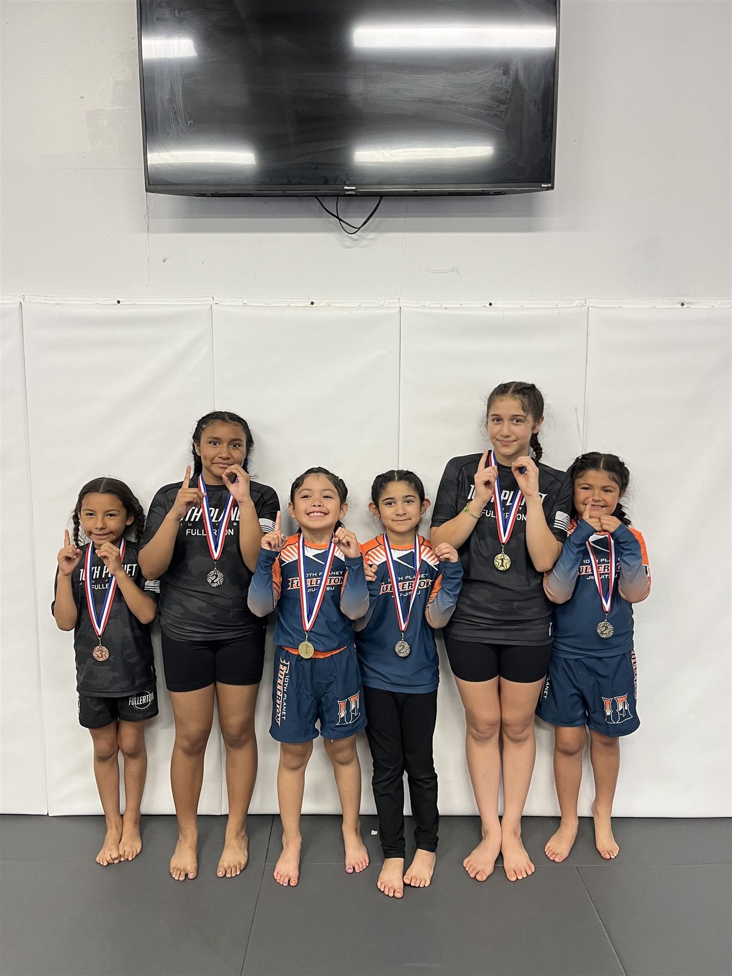 Youth jiu-jitsu competition team with medals at 10th Planet Orange